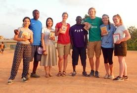 Volunteer Language Courses Volunteers pose with books on a language course add-on placement in Ghana