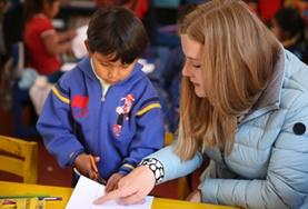 Volunteer Care A Care & Community volunteer assists a child at a placement in Peru