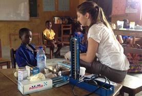 Volunteer Medicine and Healthcare A volunteer works with children during a Public Health discussion on a placement in Ghana