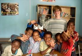 Volunteer Care Children pose with a volunteer on a Care placement in Ethiopia