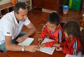 Volunteer Care A Care volunteer assists children with their school work at a placement in Peru