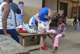 Volunteer Christmas A volunteer assists a child on a placement in Ghana
