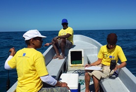 Volunteer Belize Conservation volunteers travel on a boat with local staff to find a suitable dive spot off the coast of Belize in the Caribbean.