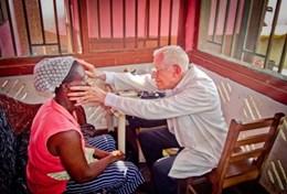 Volunteer Medicine & Healthcare A volunteer inspects a patient while on a Doctor Project placement in Ghana