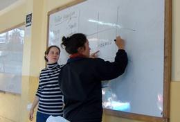 Volunteer Teaching Volunteer Maths Teachers write on a whiteboard at a placement in Peru