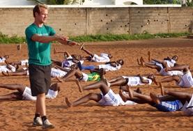 Volunteer Teaching A Physical Education Teaching volunteer runs a fitness session with students on a placement in Ethiopia