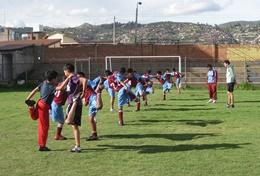 Volunteer Teaching Children warm up with their volunteer Physicasl Education Teacher at a placement in Peru