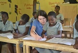 Volunteer Teaching A volunteer assists a child with school work on a Teaching Project placement in Ghana