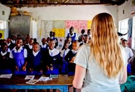 Volunteer Teaching A teaching volunteer stands in front of a classroom at a placement in Kenya