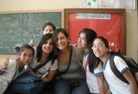 Volunteer Teaching A volunteer poses with students in a classroom on a French Teaching Project in Argentina