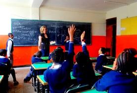 Volunteer Teaching Students raise their hands in a classroom in Ethiopia