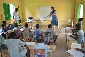 Volunteer Teaching A teacher deomstates to a class during a lesson