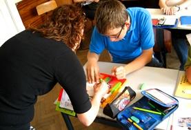 Volunteer Romania A Frecnh teaching volunteers works with a student at a placement in Romania