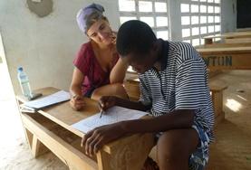 Volunteer Togo A French teaching volunteer assists a student at a placement in Togo